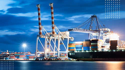 Cargo container ship docked at port at night
