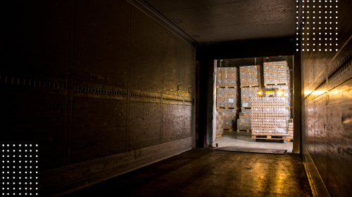 Boxes of Freight on Pallets at back of semi truck trailer