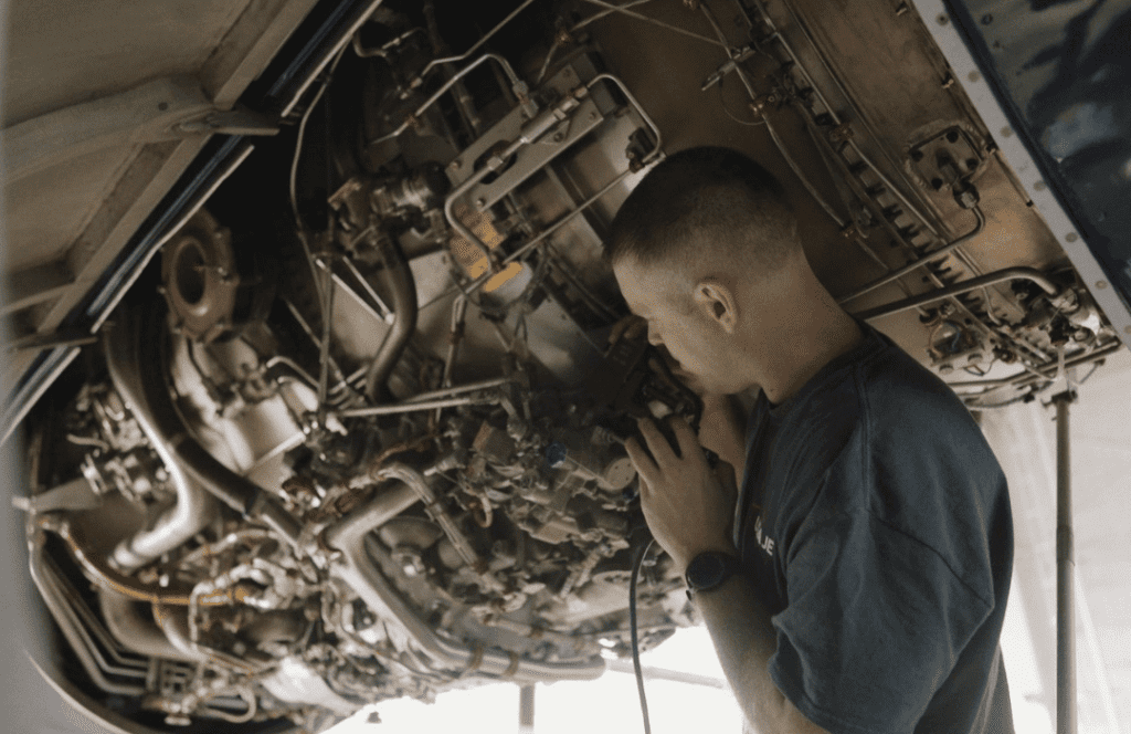 aerospace mechanic working on aircraft engine